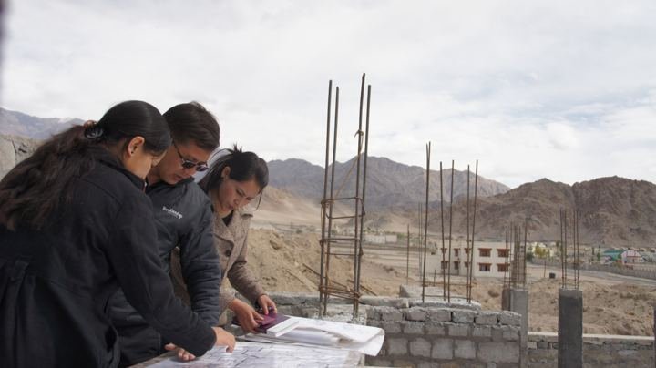 Reviewing building drawings on site, Leh